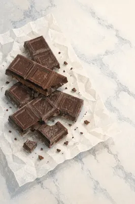 Broken Dark Chocolate on Marble Surface