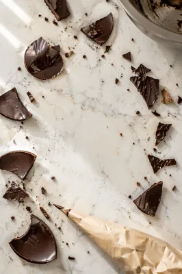 Broken Dark Chocolate on Marble Flat Lay