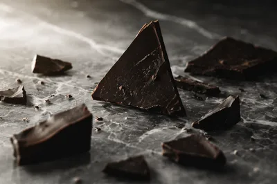 Broken Dark Chocolate on Marble Surface