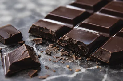 Broken Dark Chocolate on Marble Surface