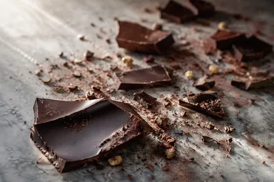 Broken Dark Chocolate on Marble Surface