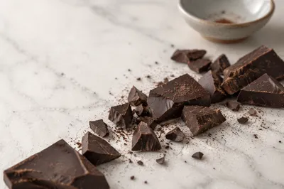 Broken Dark Chocolate on White Marble