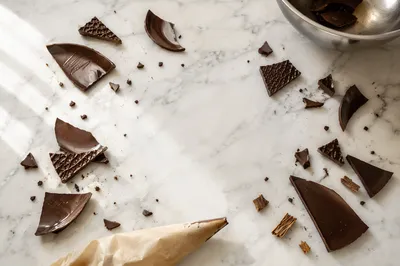 Broken Dark Chocolate on Marble Flat Lay