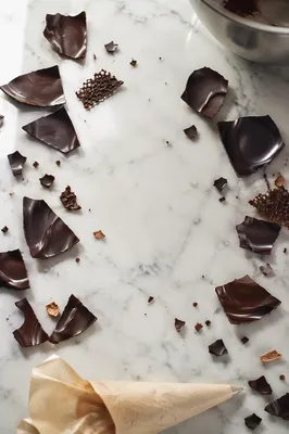 Broken Dark Chocolate on White Marble