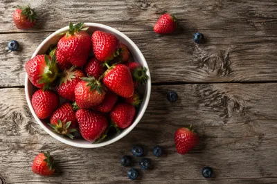 Overhead Fresh Berry Bowl on Rustic Wood