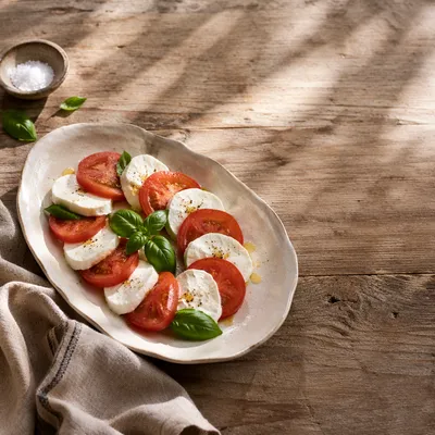 Sunlit Caprese Salad on Rustic Table