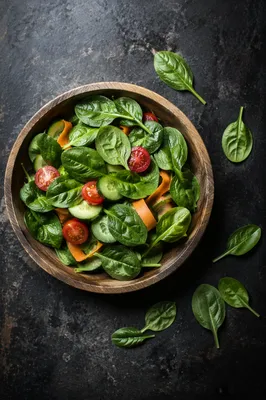 Fresh Spinach Salad Bowl on Dark Slate