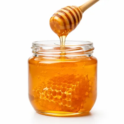 Golden Honey Dripping Into Glass Jar