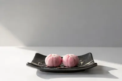 Minimal Pink Wagashi on Black Ceramic Plate