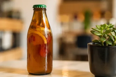 Artisanal Fruit Kombucha Bottle on Café Table