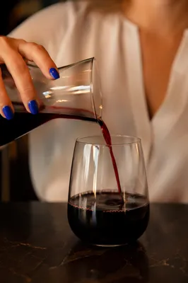 Elegant Red Wine Pour with Cobalt Nails