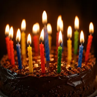 Lit Candles on Chocolate Birthday Cake