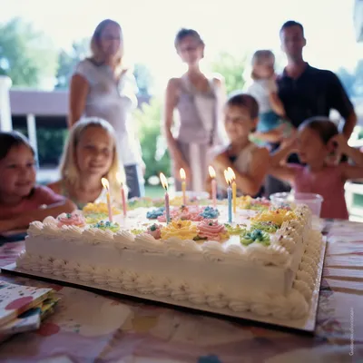 Lit Birthday Candles on Frosted Cake