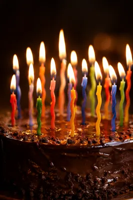 Glowing Candles on Chocolate Birthday Cake