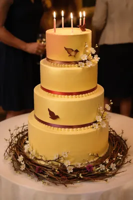 Warm Candlelit Four Tier Birthday Cake