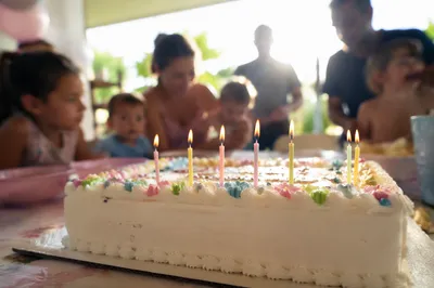 Lit Birthday Candles on Celebration Cake