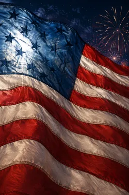 Patriotic Fireworks Behind Rippling Flag Banner