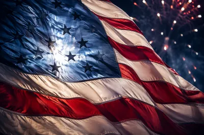 Patriotic Fireworks Behind American Flag Banner