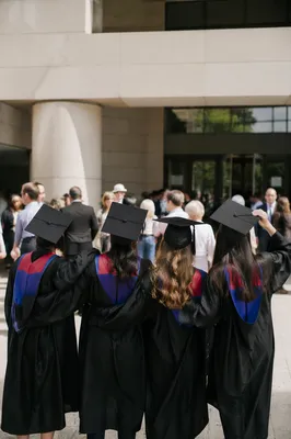 Graduates Celebrating Outside Modern Campus Hall