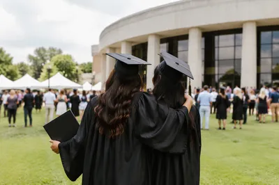 Graduates Celebrating Together on Campus Lawn