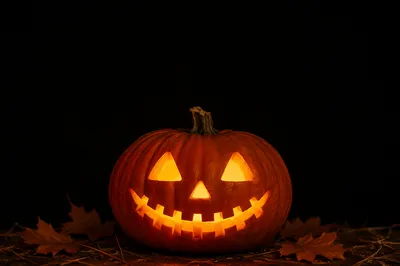 Glowing Carved Halloween Pumpkin on Black