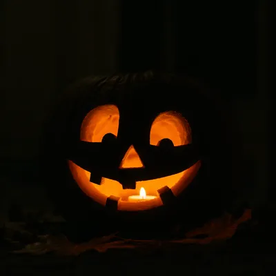 Glowing Jack O Lantern on Dark Porch