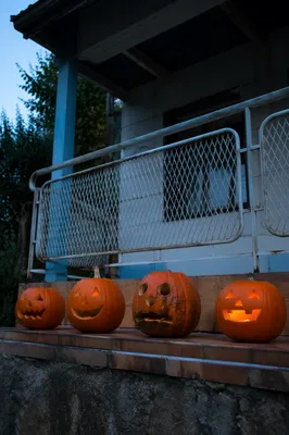 Carved Halloween Pumpkins on Porch at Dusk