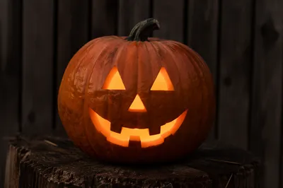 Glowing Jack O Lantern on Rustic Stump