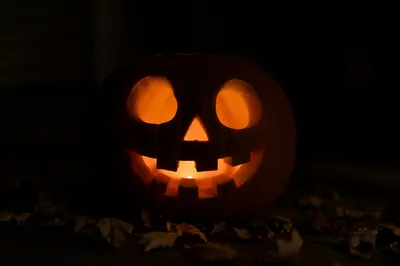 Glowing Jack O Lantern on Dark Porch