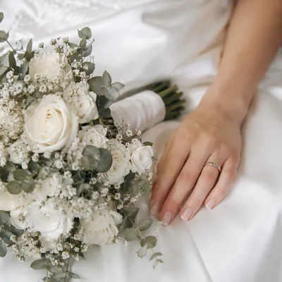 Bride Hands with White Wedding Bouquet