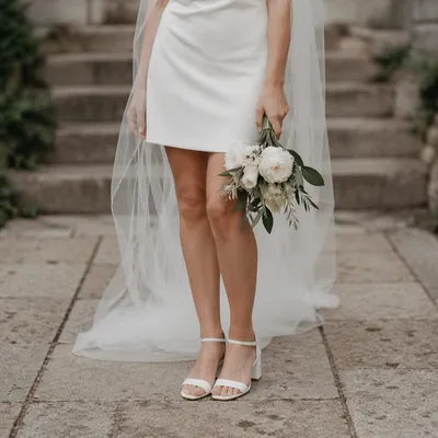 Bride with White Bouquet on Stone Walkway