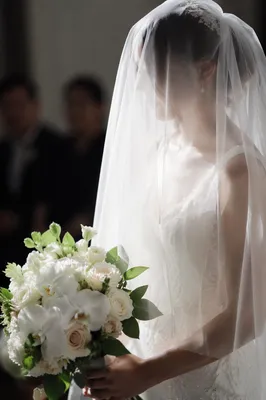 Veiled Bride Holding White Wedding Bouquet
