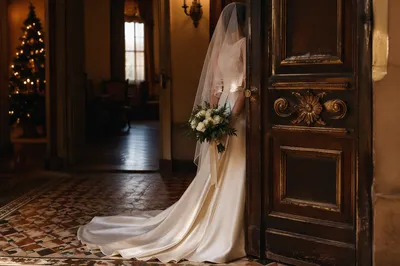 Veiled Bride with White Bouquet in Historic Venue