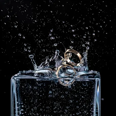 Gold Wedding Rings Splashing Into Water