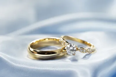 Elegant Gold Wedding Rings on Ice Blue Satin