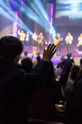 Raised Hands Facing Praise Team Stage