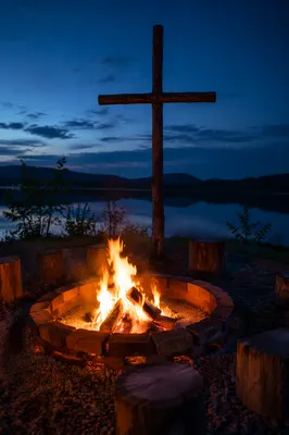 Campfire by Lake with Wooden Cross