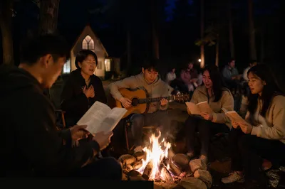Korean Group Singing by Campfire at Night