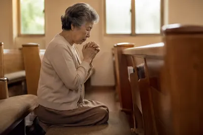 Elderly Korean Woman Praying in Church