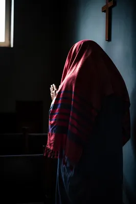 Worshipper in Prayer Shawl by Teal Wall