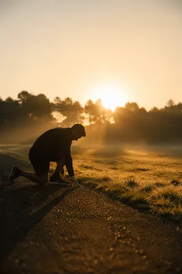Athlete Kneeling in Sunrise Prayer