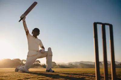 Athlete Kneeling at Sunrise on Sports Field