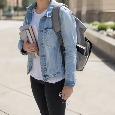 Campus Student Carrying Bible in Backpack