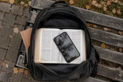 Bible in Student Backpack on Campus Bench