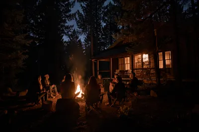 Cozy Campfire Circle by Cabin at Night
