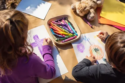 Children Drawing a Cross with Crayons