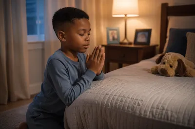 Child Praying Beside Bed at Night