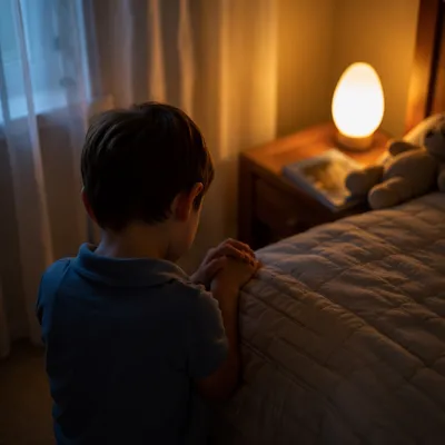 Child Praying Beside Bed in Nightlight Glow