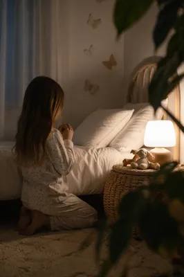 Child Praying Beside Bed at Night