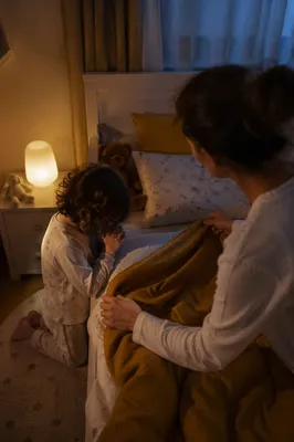 Child Praying Beside Bed at Night